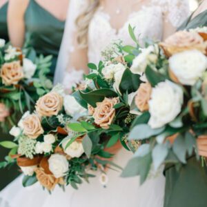 A long shot of the bride and bridesmaid holding flowers