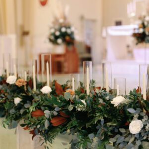 The flowers and candles on the table