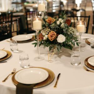 A picture of the plates and candles on the table